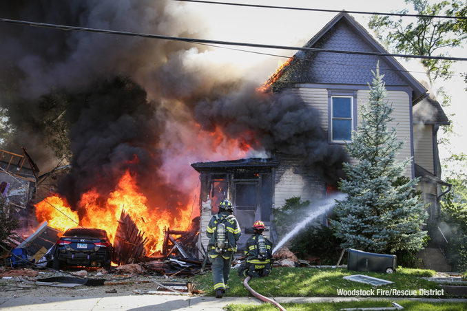 An adjacent house burns after a house explosion in Woodstock, Illinois on Monday, October 9, 2023 (Woodstock Fire/Rescue District)