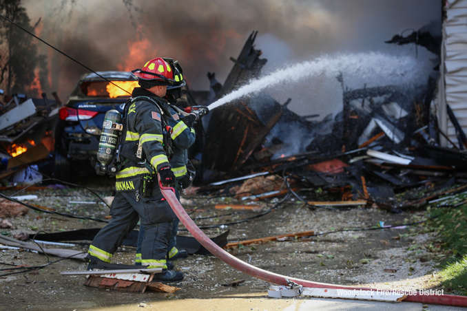Firefighters extinguishing multiple fires after a home was leveled by an apparent natural gas explosion on Monday, October 9, 2023 (SOURCE: Woodstock Fire/Rescue District)